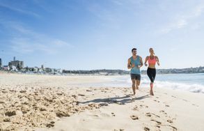 two people running along the beach on a weight loss holiday
